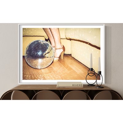 Framed Print on Rag Paper Young woman wearing high heels standing by disco ball on floor in party by Westend61 via Getty Images Gallery