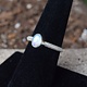 STB 001 SS Rainbow Moonstone 7mm Oval, Bezel Set Textured Snake Band, Ring Size 7