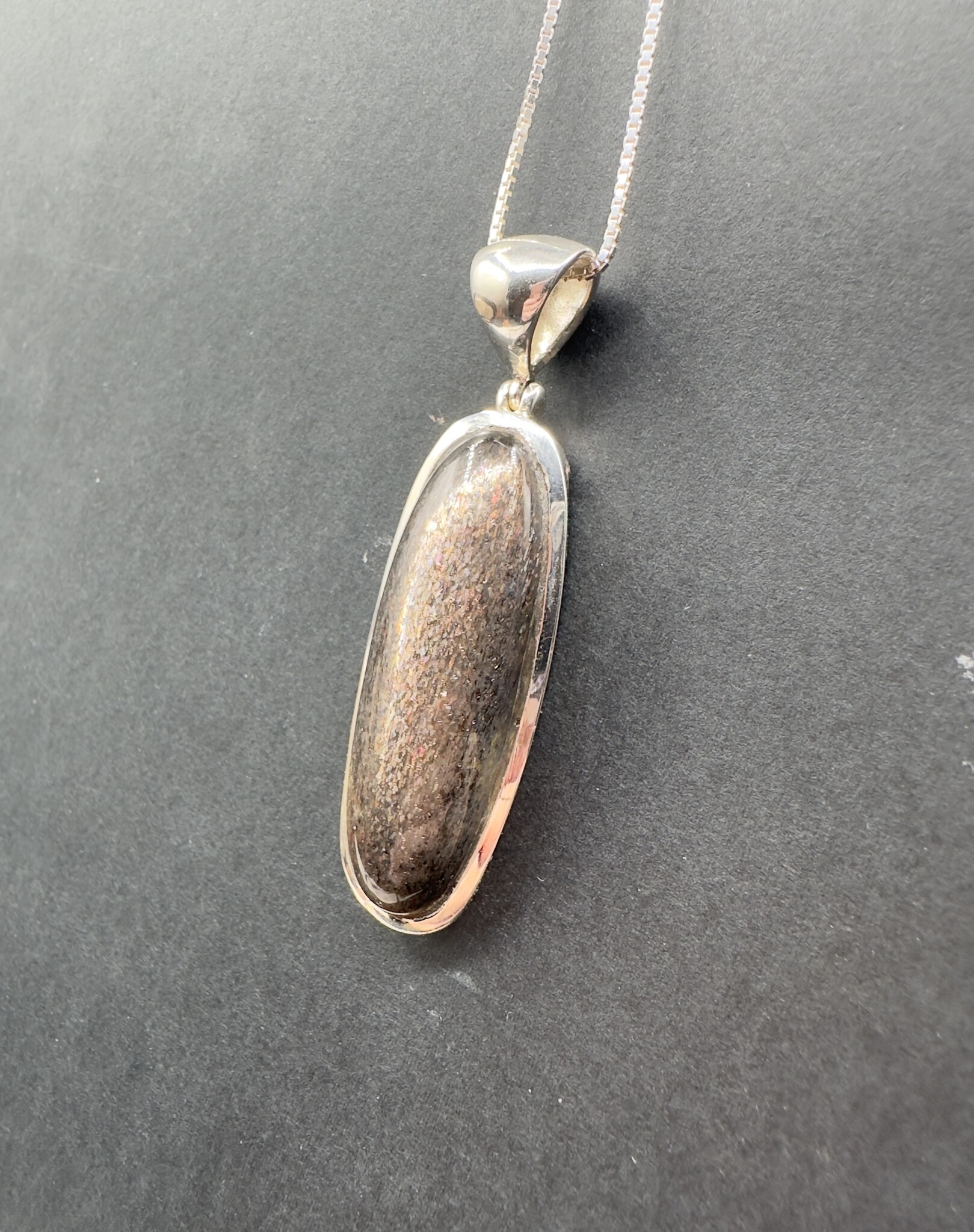 STB 001 SS Black Sunstone 13x39mm Oval Cabochon Bezel Set Pendant With Hinged Bail on 18 " Box Chain Necklace