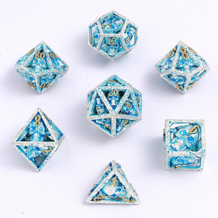 HYMGHO HYMGHO SKULL'S GRIN HOLLOW METAL DICE SET - GLOW IN THE DARK BLUE