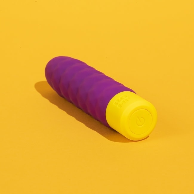 Romp Beat bullet vibrator with base facing viewer, a large yellow button with power symbol is clearly visible