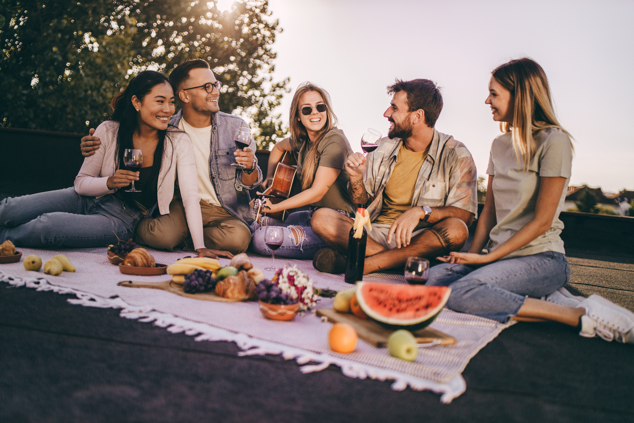 friends having picnic with wine