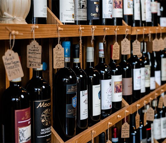 Wine professional pouring glass in boutique cellar