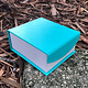 DBX4354 = Deluxe Magnetic Teal/White Earring/Pendant Box (Each)