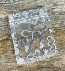 DBX1293HW = Organza Drawstring Pouches White with Silver Hearts 3''x4'' (Pkg/10)