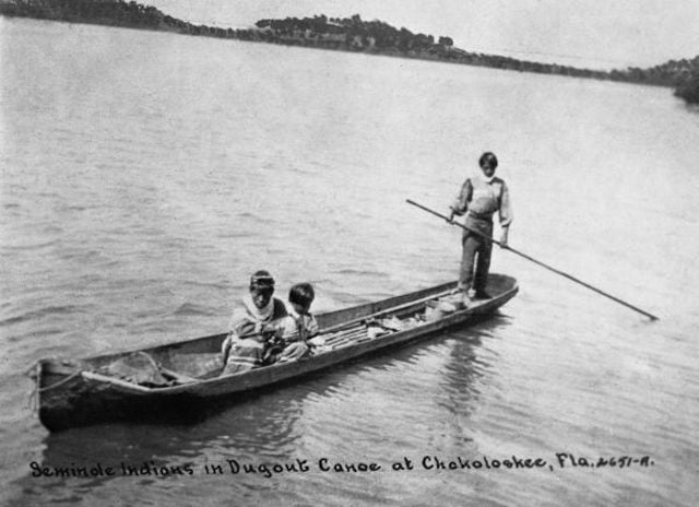 stand up paddling in dugout canoe