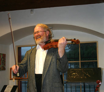 Violinist David Stenske compares violins at Metzler's annual Italian Violin sale on January 9, 2005.