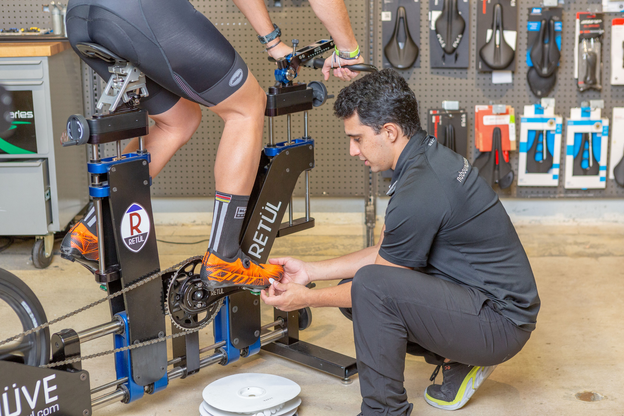 man adjusting cyclist shoes