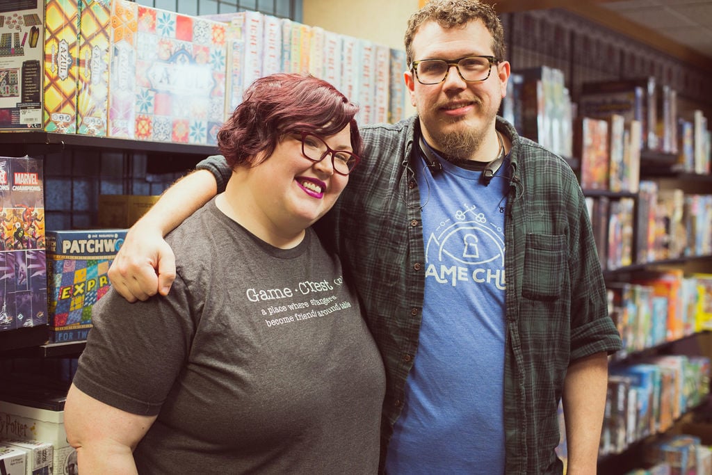 Ben and Amanda Wermers in front of board games in Game Chest.
