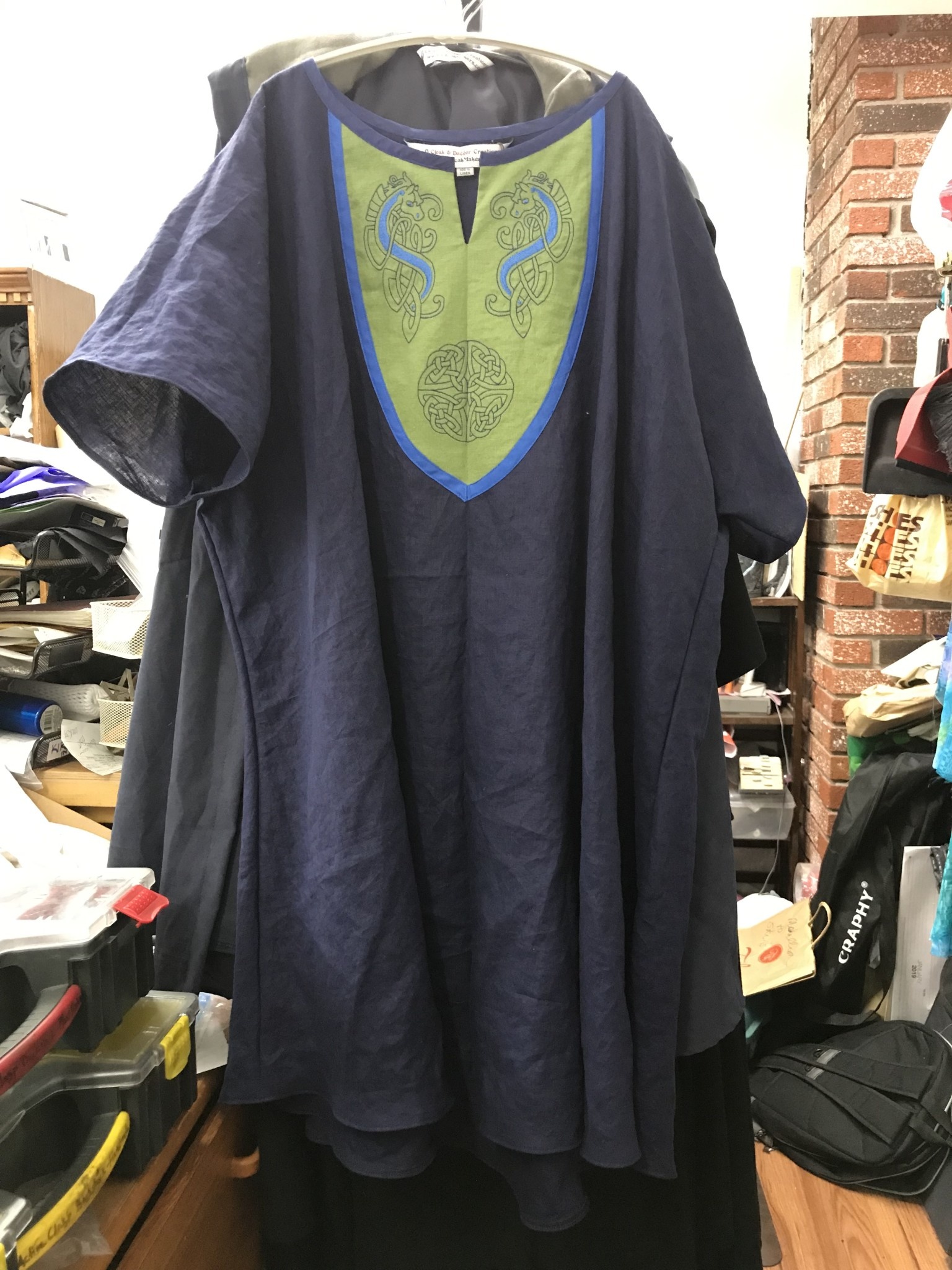 J774 - Dark Blue Short Sleeve Tunic w/Celtic Horse and Round Knot  Embroidery in Blues on Green Panel w/ Bright Blue Edging