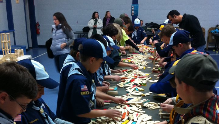 Boy Scouts engaged in sorting blocks before building a bridge