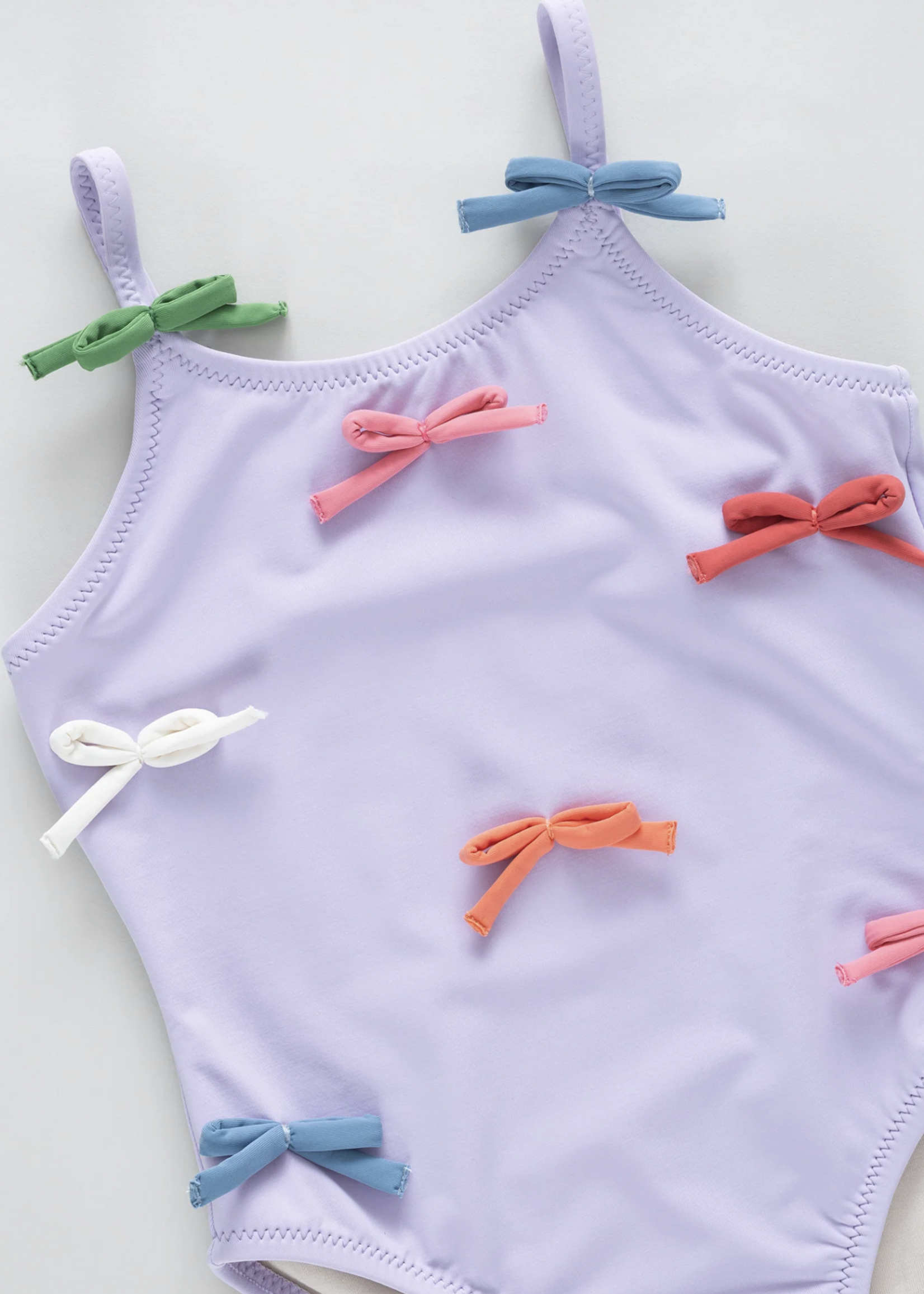 Pink Chicken girls lottie suit - lavender multi bow applique