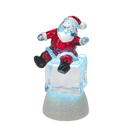 Père Noël sur cube de glace illuminé