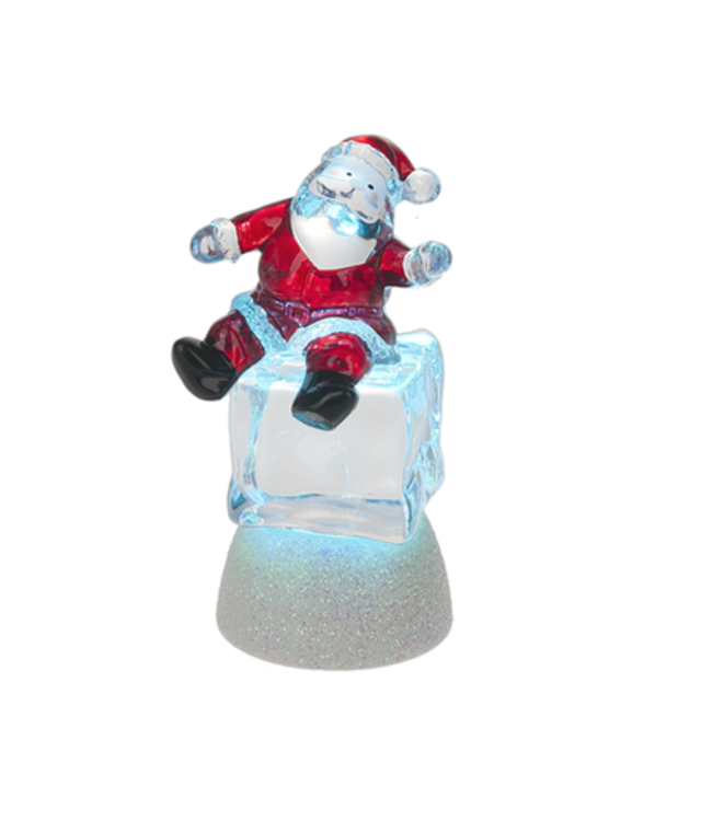 Père Noël sur cube de glace illuminé