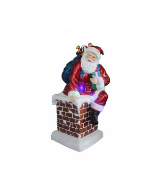 Père-Noël dans une cheminée avec lumières