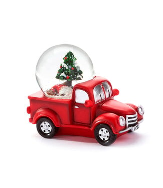 Boule à neige sapin dans un camion rouge