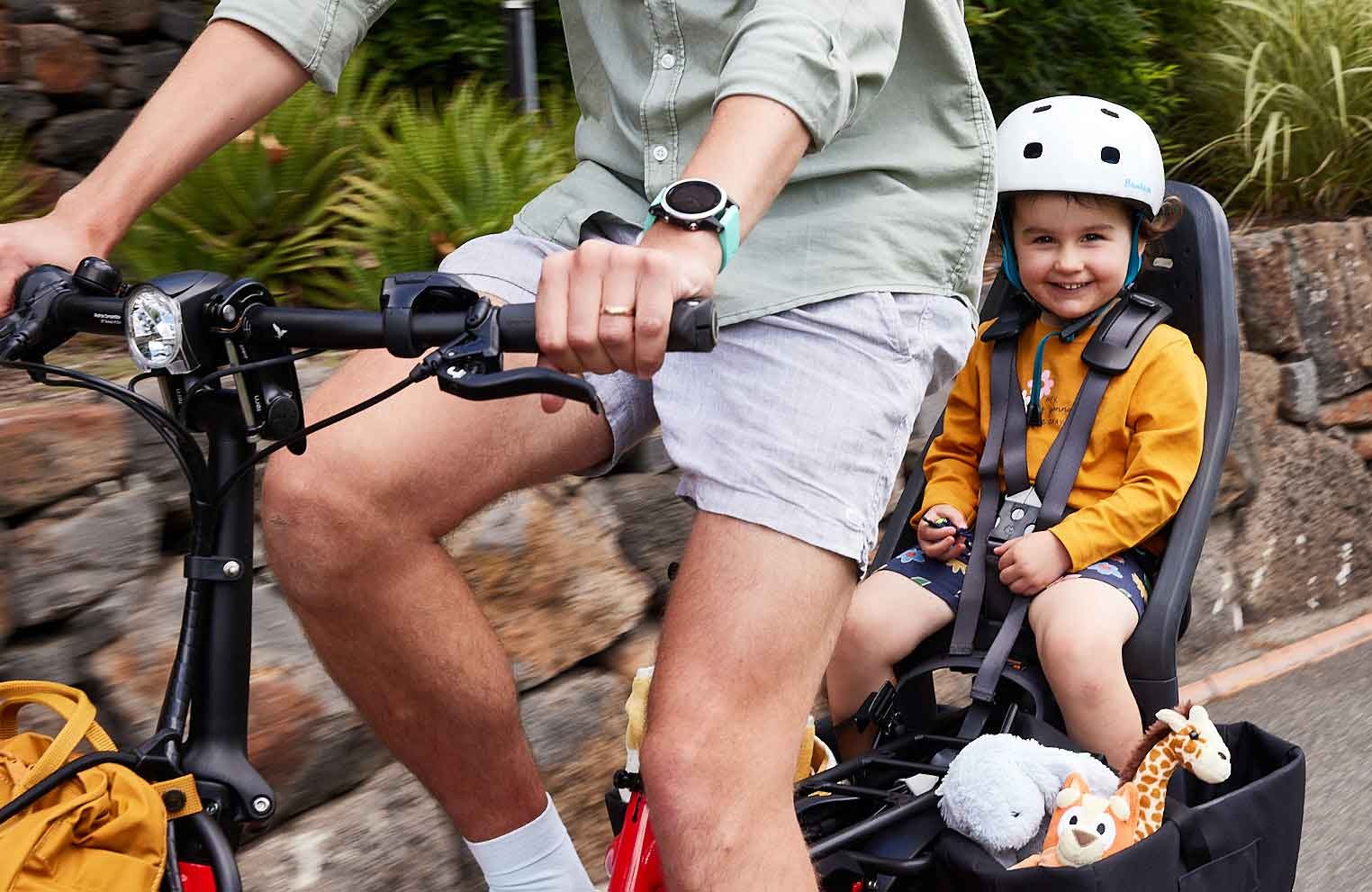 Person riding a Tern with child on rear of bike