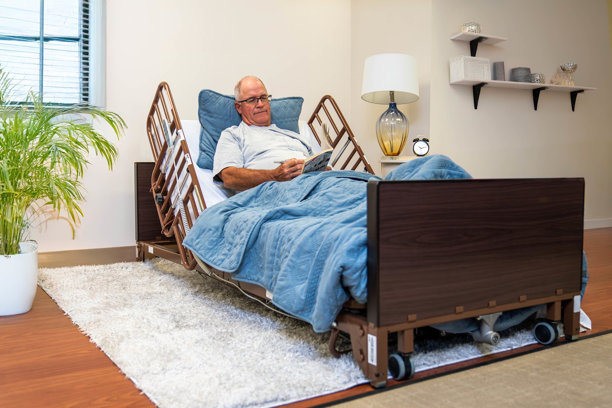 ProBasics low full-electric bed with a mattress and half rails, shown in a home setting