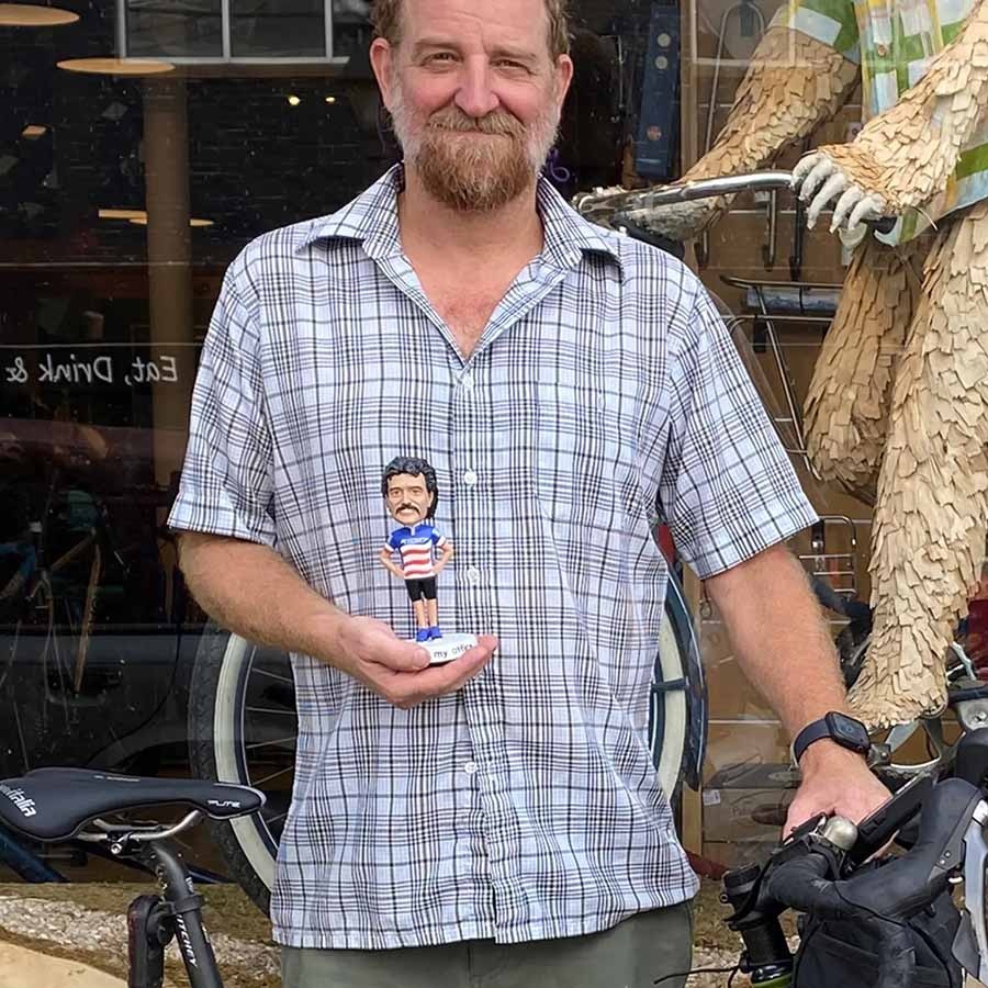 Glenn holding a Tom Ritchey bobble head