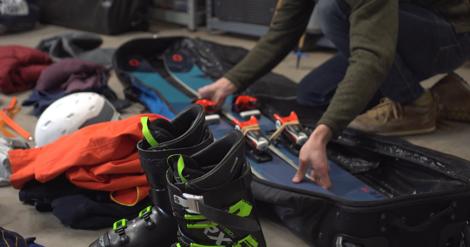 man storing ski equipment