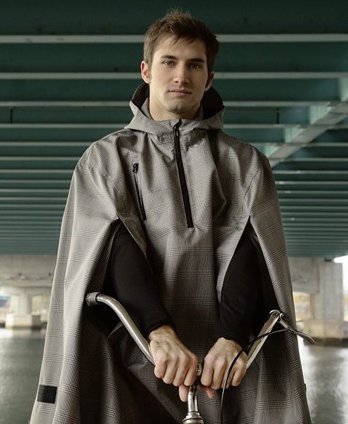 A cyclist wearing a rain cape