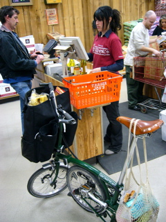 Checkout. Notice string mesh bag off saddle to balance heavy front bag load on skate-wheel fulcrum.