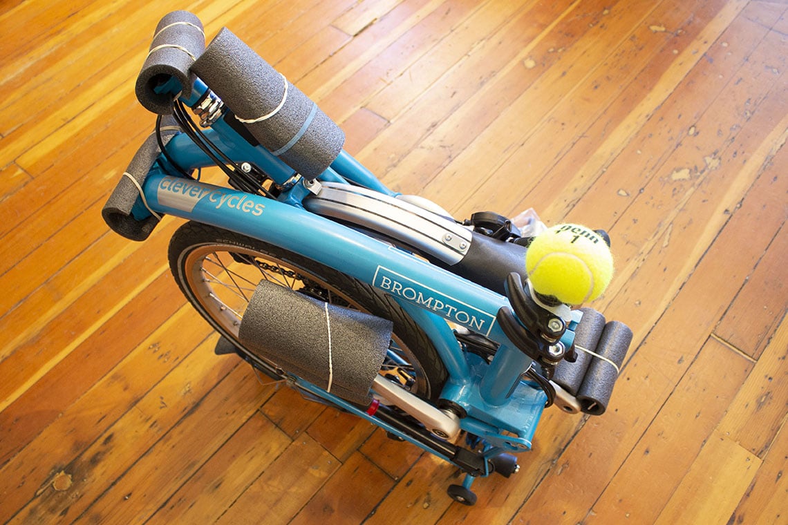 A Brompton folding bike prepared for gate check at airport