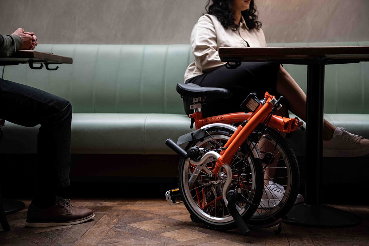 Folded bicycle under a restaurant table