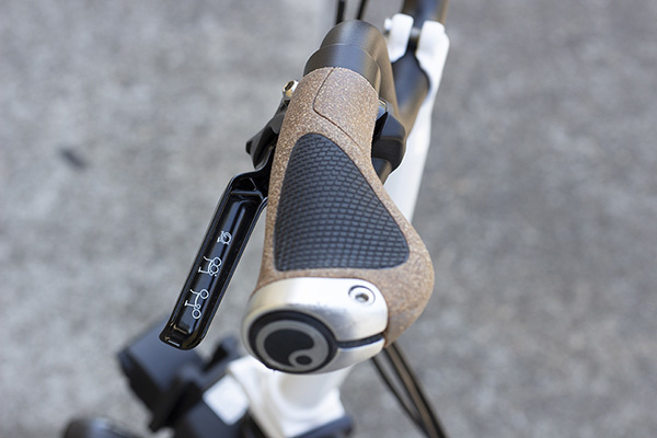 A winged cork and black rubber grip on a black Brompton handlebar
