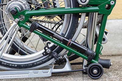 A black pump fastened to the seat stay tube of a Brompton bike