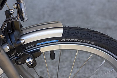 Closeup of a Brompton's small wheel with a silver rim and black tire