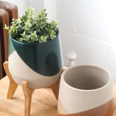 Pot on wooden stand