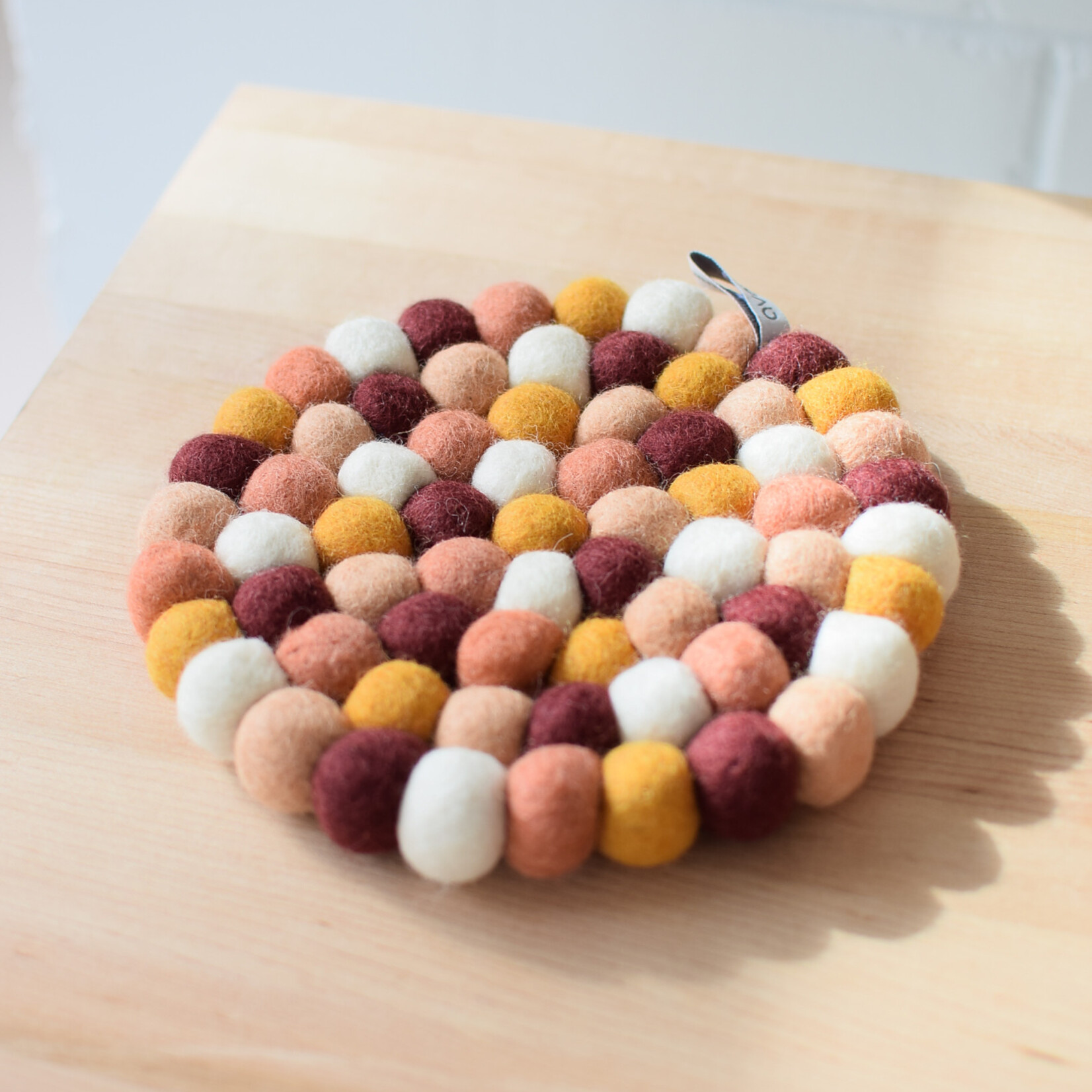 Place mat with orange pompons