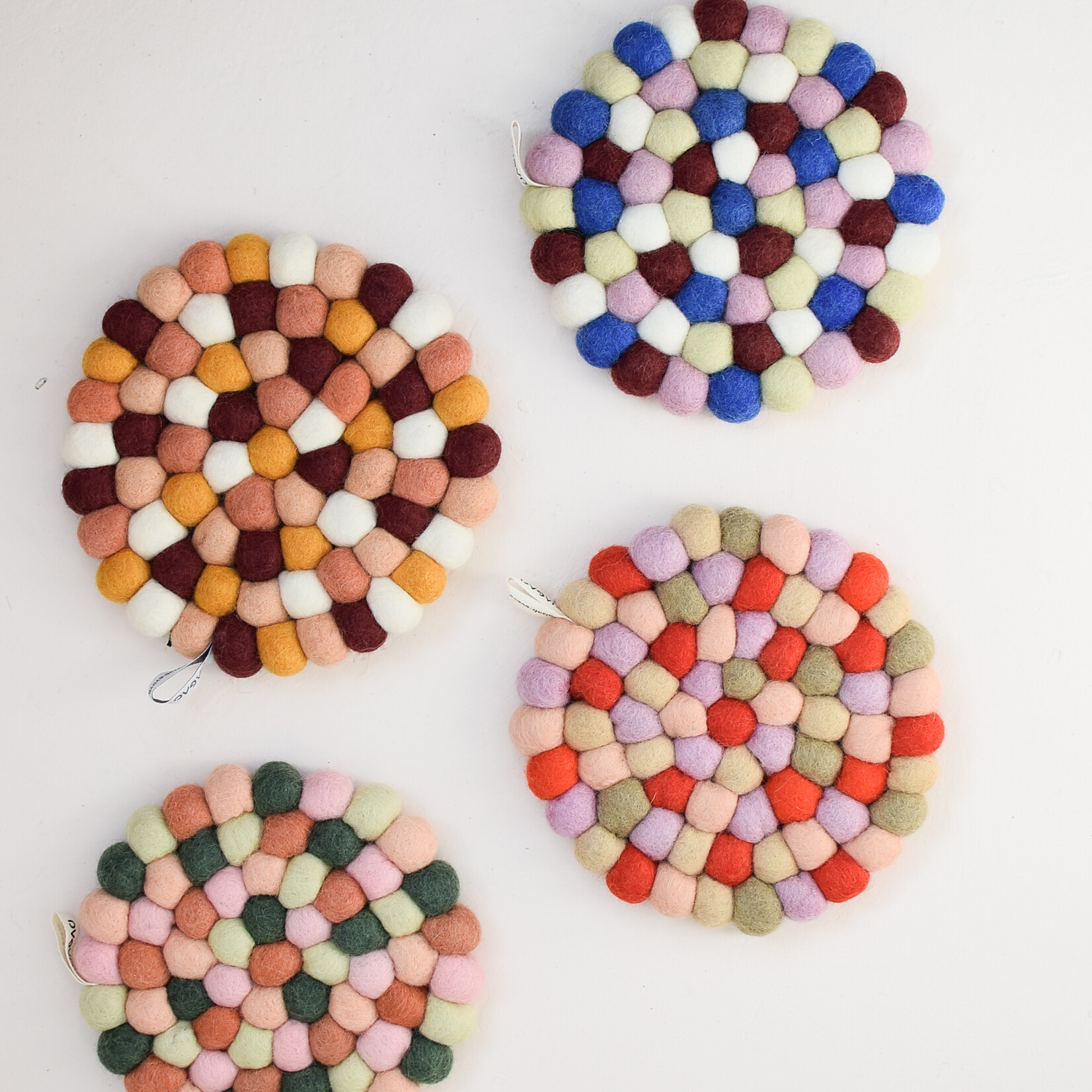 Red pom-pom trivet