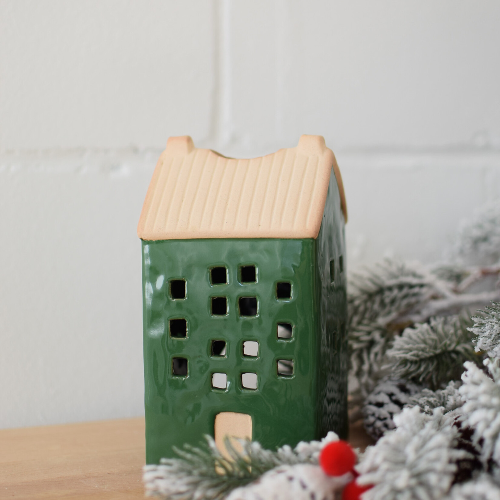 Green and beige house candle jar