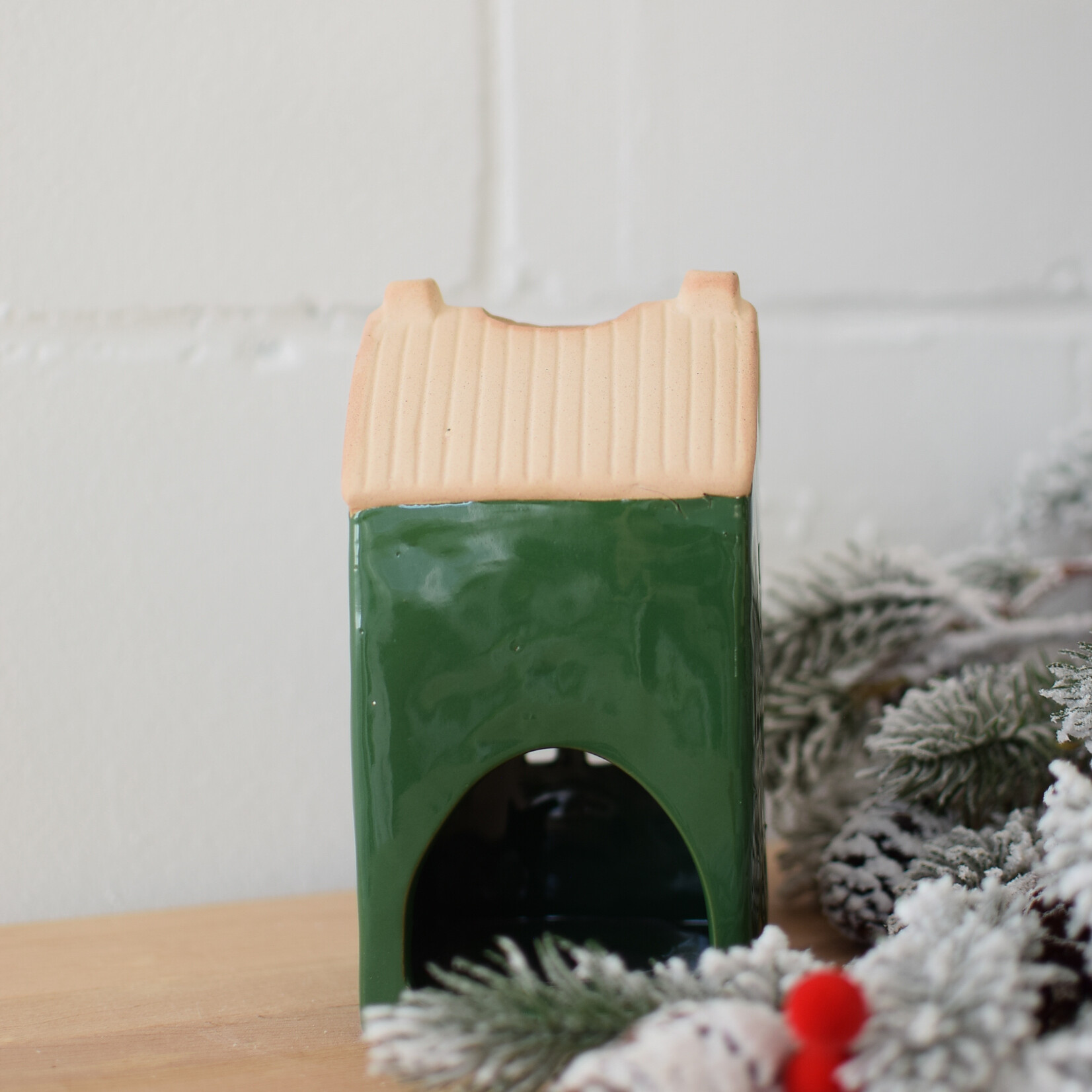 Green and beige house candle jar