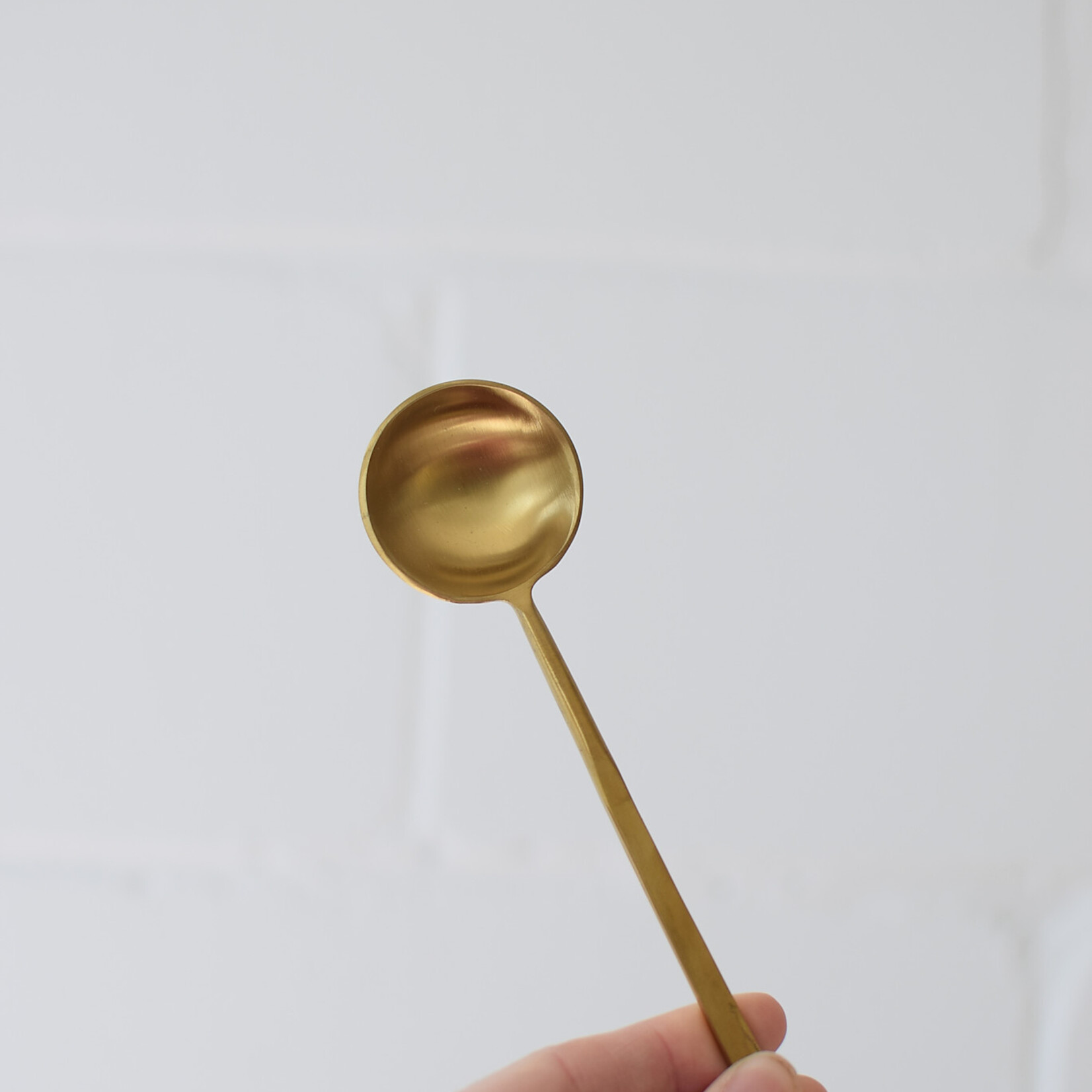 Long golden spoon