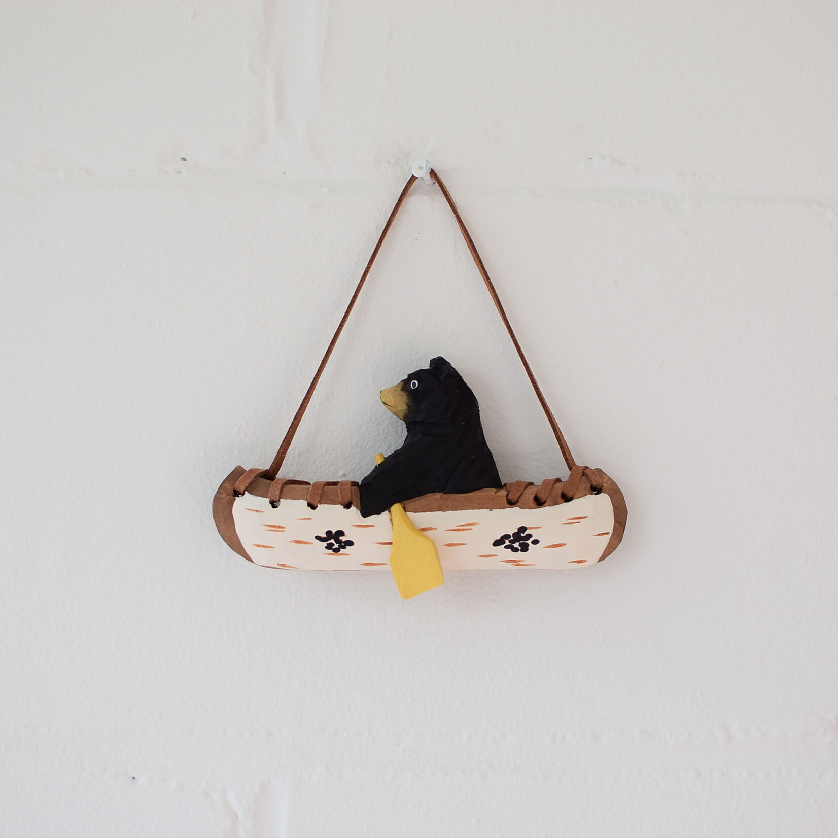 Carved ornament - Bear in a canoe