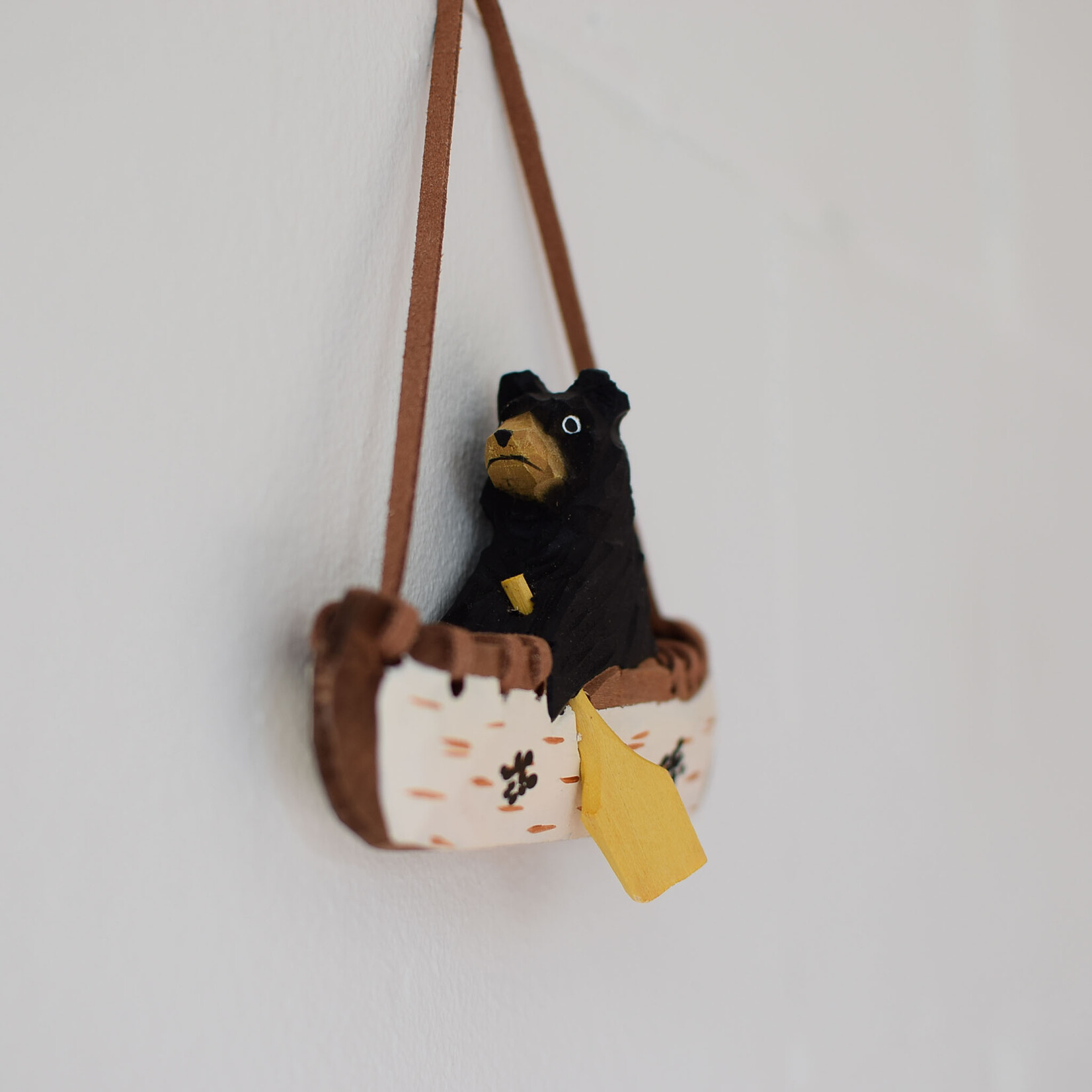 Carved ornament - Bear in a canoe