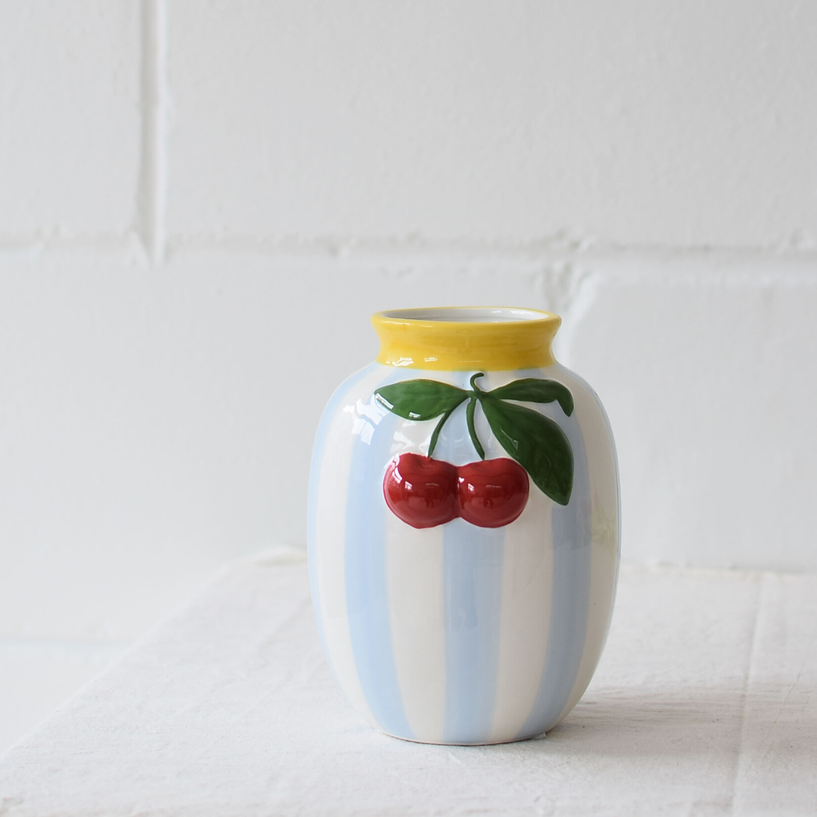 Vase with blue stripes and cherries