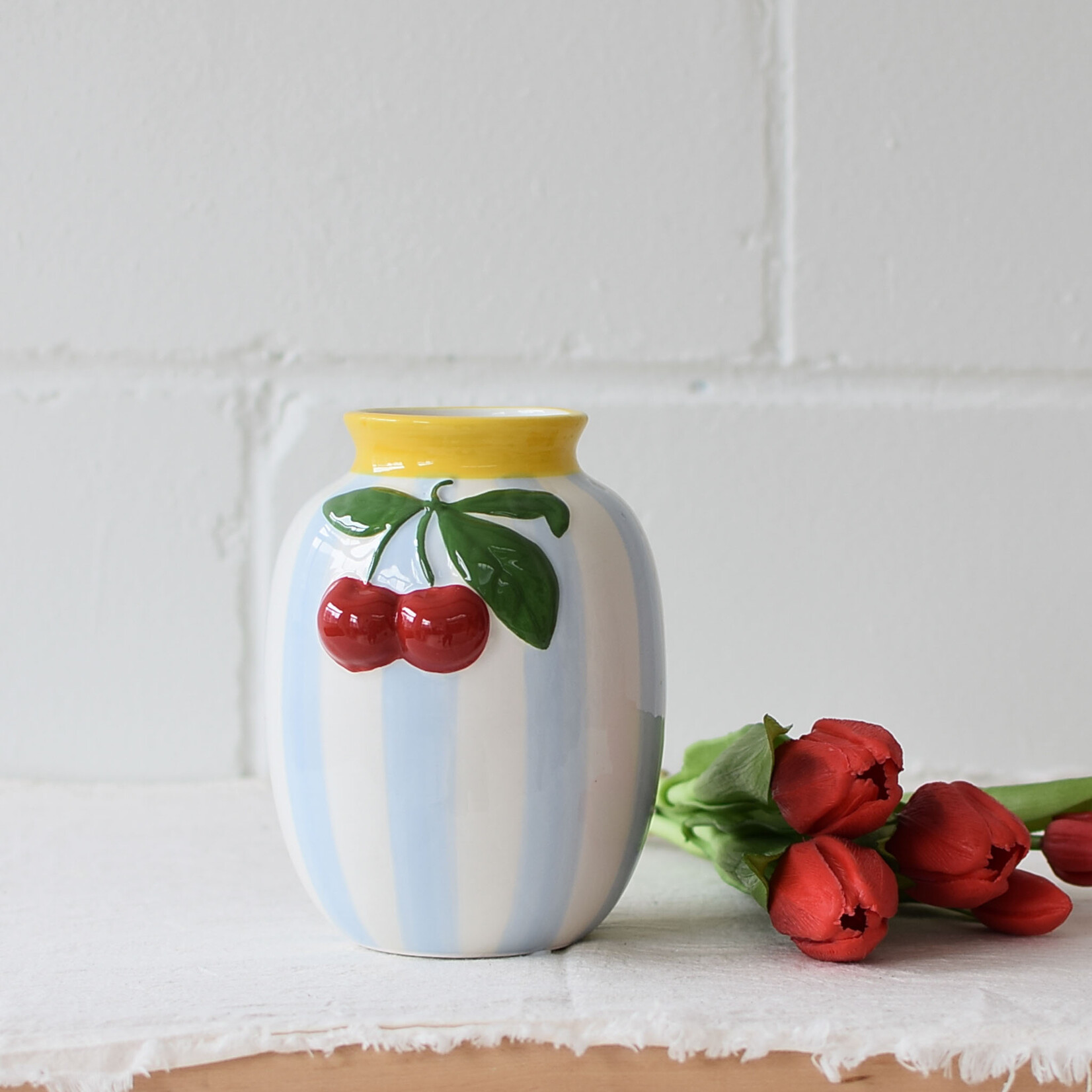 Vase with blue stripes and cherries