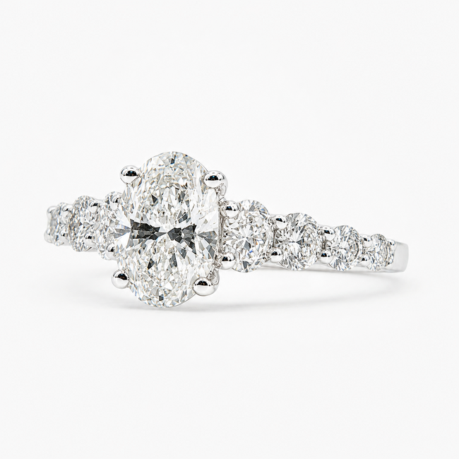Ring Graduated 1.01ct Oval Lab Grown Diamond IGI Report: 756503774 VVS2 E .90ctw Round Diamonds 14kw 2mm Sz7 2.1g 125060061