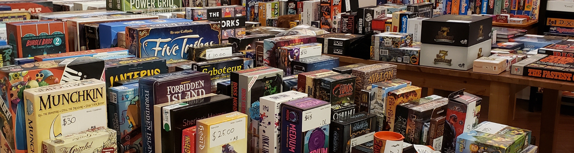 Lots of board games neatly stacked on tables
