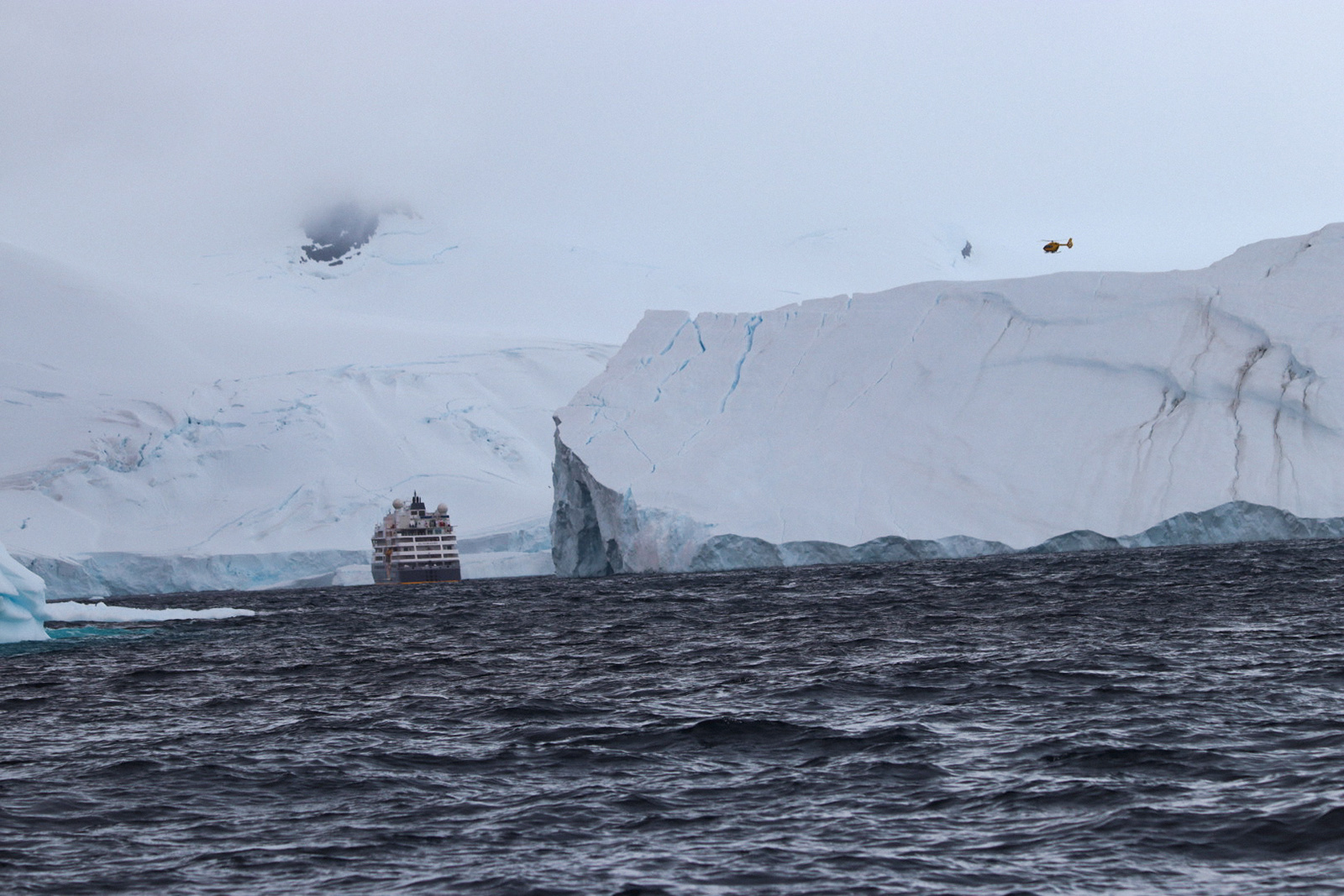 Antarctica - Ship dwarfed by icebergs