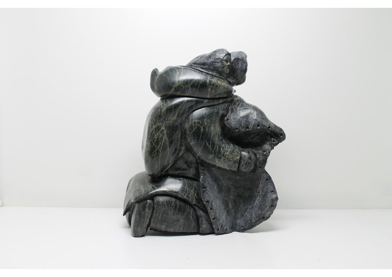 712 Woman skinning by Archie Ishulutak