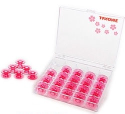 Janome 25 pink bobbins in display case