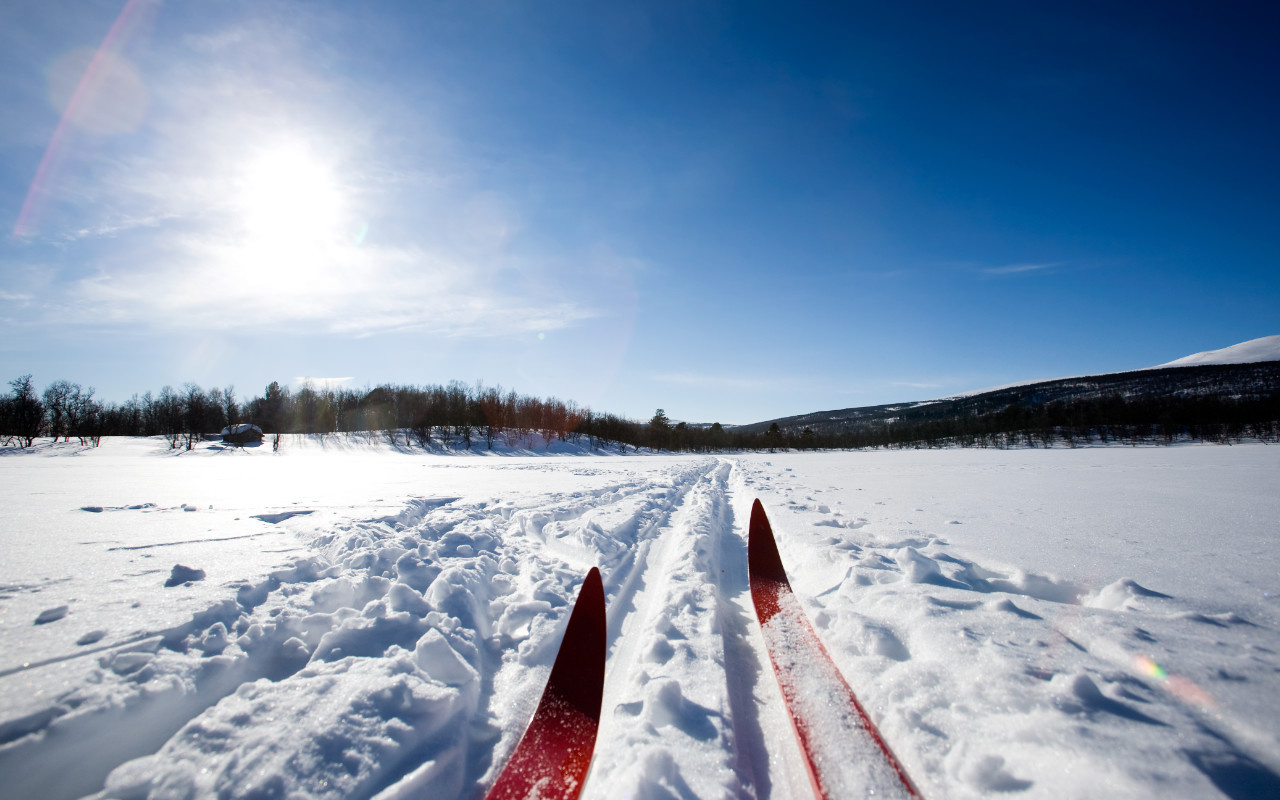 vue en gros plan de skis de fonds dans la neige sur un lac gelé