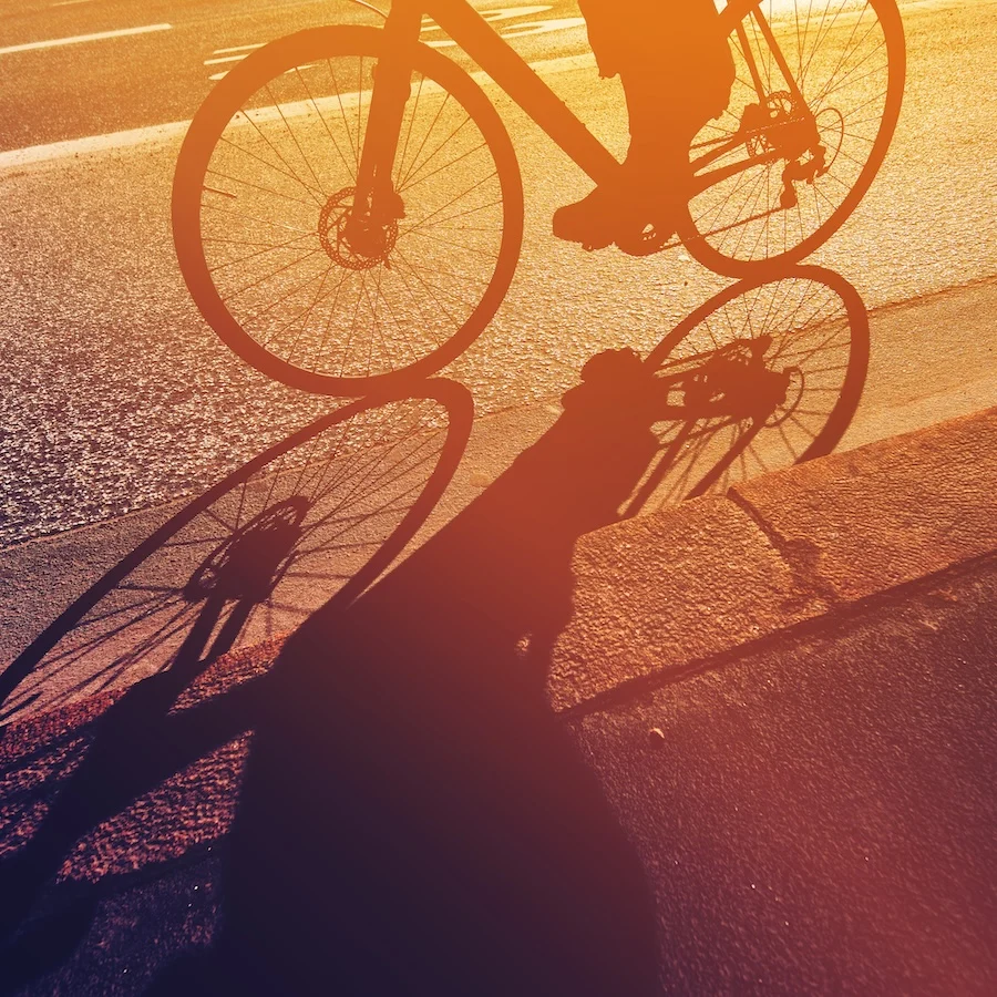 Vélo de route projetant une ombre au sol pour illustrer la position du cycliste et le centre de gravité.