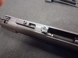 MWS nozzle being removed from the bolt carrier group