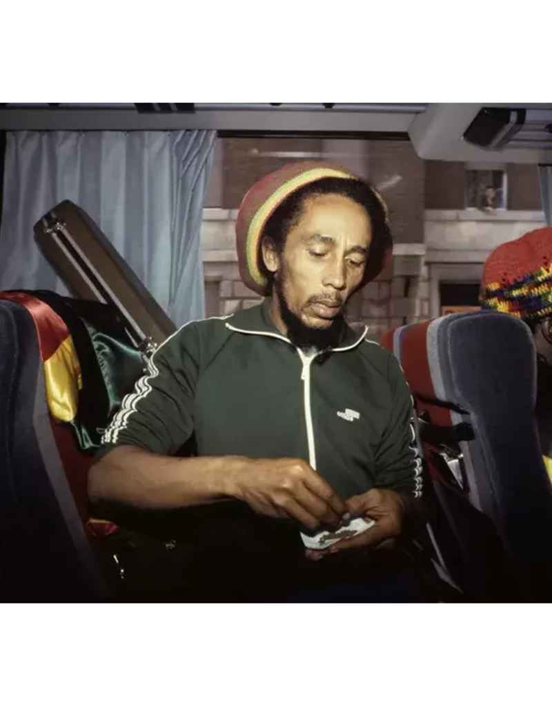 Goldsmith Bob Marley Roll Joint on Bus, 1980 by Lynn Goldsmith
